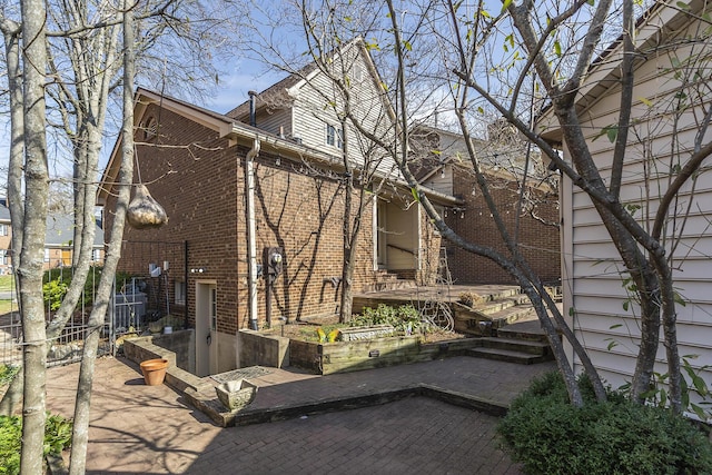 view of home's exterior with brick siding