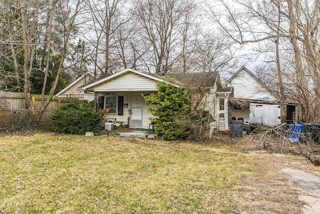 bungalow-style house featuring covered porch, a front yard, and fence