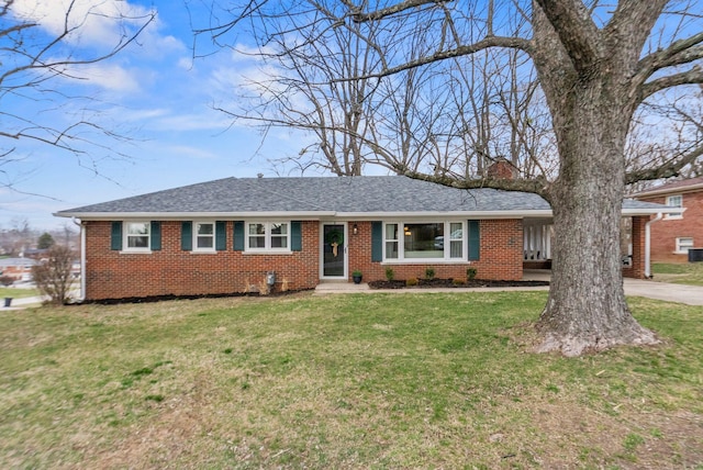 ranch-style house with a front lawn, brick siding, roof with shingles, and a chimney