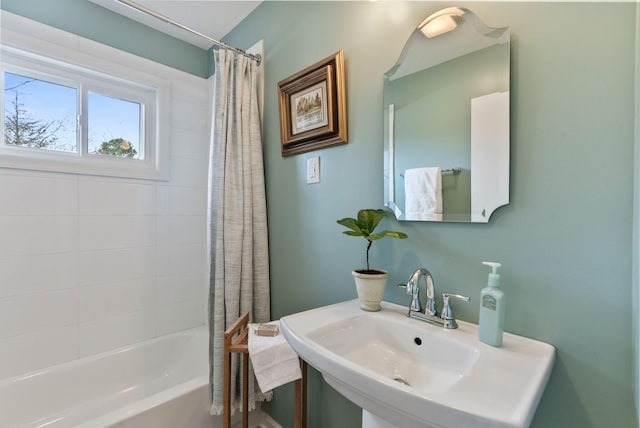 full bath featuring shower / bath combo and a sink