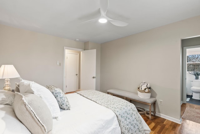 bedroom featuring ensuite bath, wood finished floors, baseboards, and ceiling fan