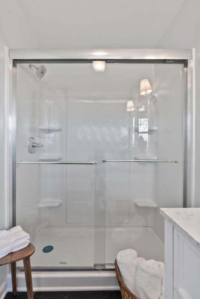 full bathroom featuring a shower stall and vanity