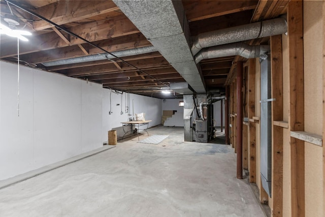 unfinished basement featuring heating unit