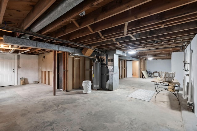 unfinished basement featuring heating unit and water heater