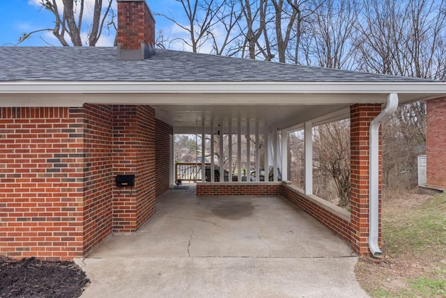 view of patio / terrace with an attached carport and concrete driveway