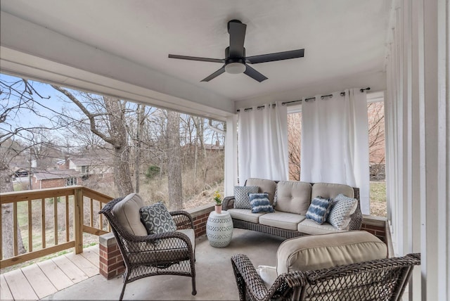 sunroom / solarium with a ceiling fan