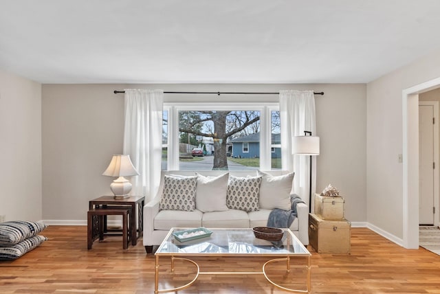 living area with wood finished floors and baseboards