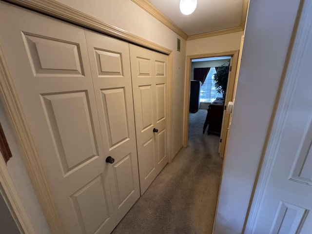 hallway with light colored carpet and crown molding