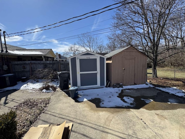 view of shed featuring fence