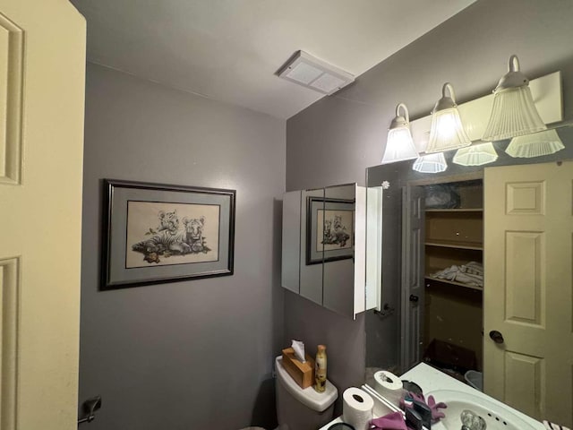 bathroom with toilet and visible vents