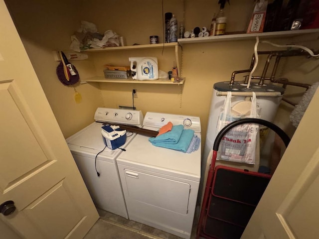 washroom with tile patterned flooring, washing machine and dryer, laundry area, and water heater