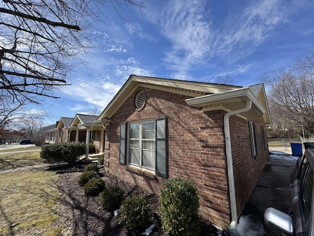 view of side of property with brick siding