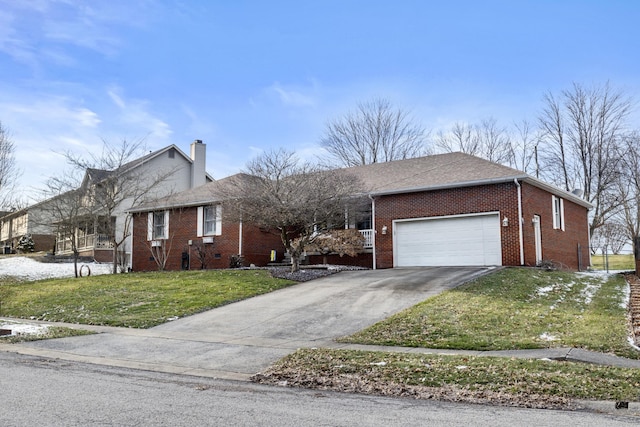 ranch-style home featuring a front yard, a chimney, concrete driveway, a garage, and brick siding