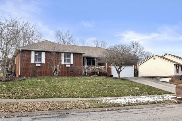 view of front of house with a garage, brick siding, a front yard, and aphalt driveway