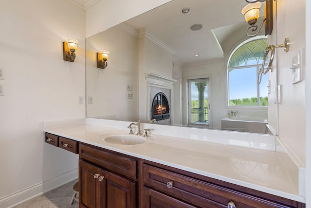 bathroom with crown molding, baseboards, a premium fireplace, recessed lighting, and vanity