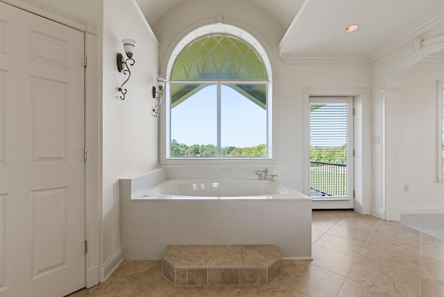 bathroom with tile patterned floors, crown molding, and a garden tub