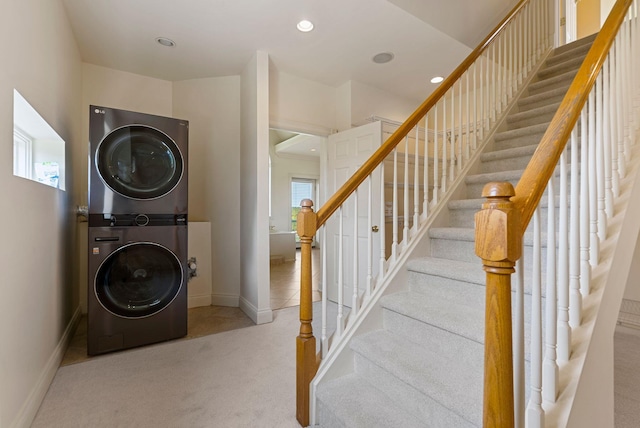 interior space featuring baseboards, carpet, stacked washer and dryer, laundry area, and recessed lighting