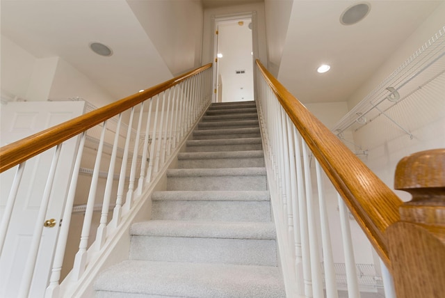 staircase with recessed lighting