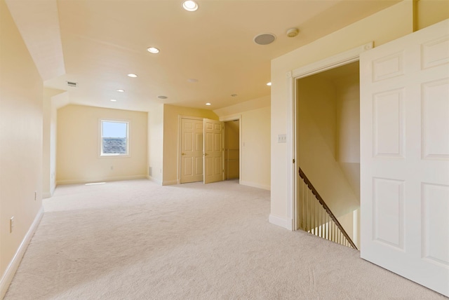 unfurnished room with visible vents, recessed lighting, light colored carpet, and baseboards