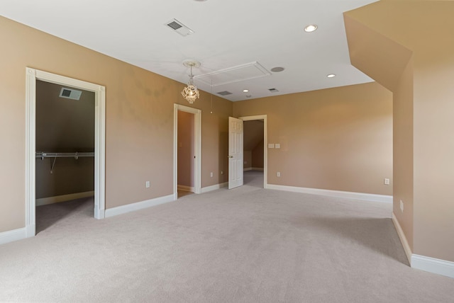 empty room featuring recessed lighting, visible vents, baseboards, and attic access