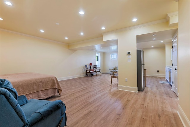 bedroom featuring baseboards, light wood-type flooring, freestanding refrigerator, and ornamental molding