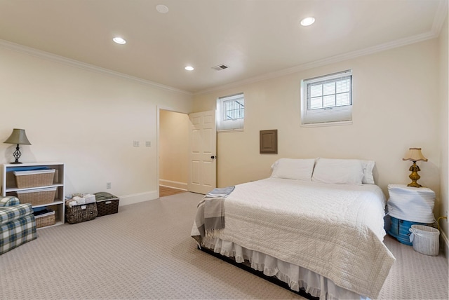 carpeted bedroom with visible vents, crown molding, and baseboards