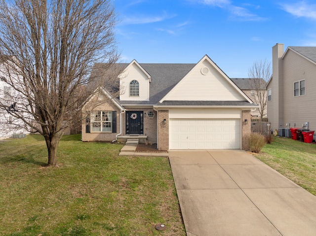 view of front of home with a front lawn, fence, concrete driveway, an attached garage, and brick siding