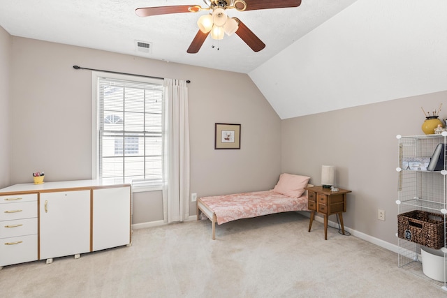 bedroom with visible vents, baseboards, ceiling fan, vaulted ceiling, and light colored carpet