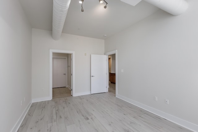 unfurnished bedroom with baseboards and light wood finished floors