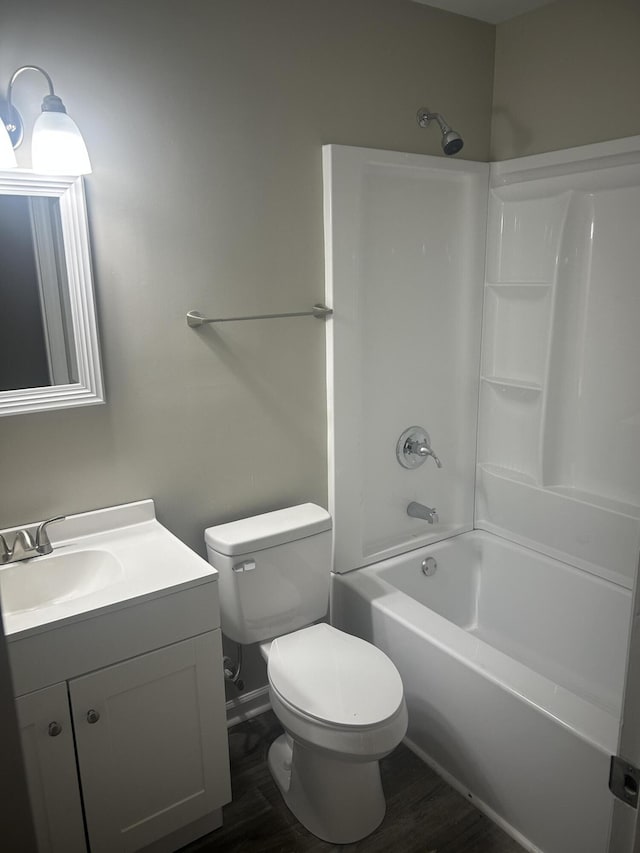 bathroom with toilet, vanity, bathtub / shower combination, and wood finished floors