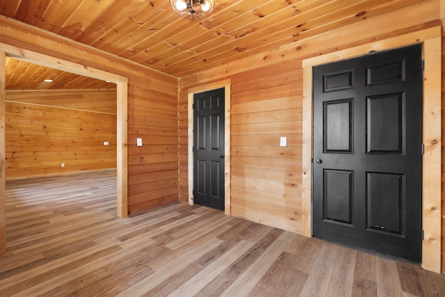 interior space featuring wood finished floors, wood ceiling, and wood walls