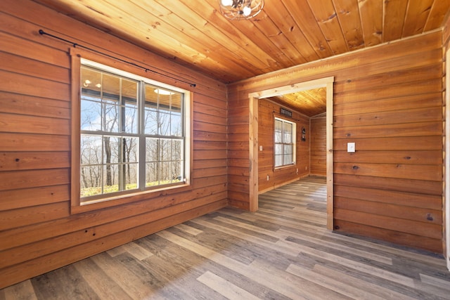 empty room featuring wood ceiling and wood finished floors