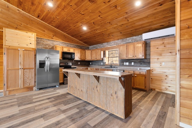 kitchen featuring a wall mounted AC, a kitchen island, a sink, stainless steel appliances, and wooden ceiling