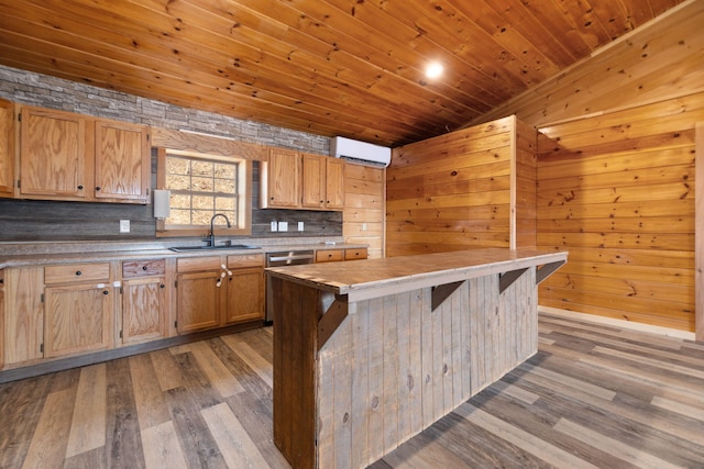 kitchen featuring wood finished floors, wooden ceiling, an AC wall unit, and a sink