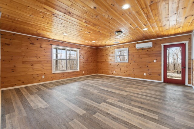 spare room featuring wooden ceiling, wood finished floors, a wealth of natural light, and a wall mounted AC