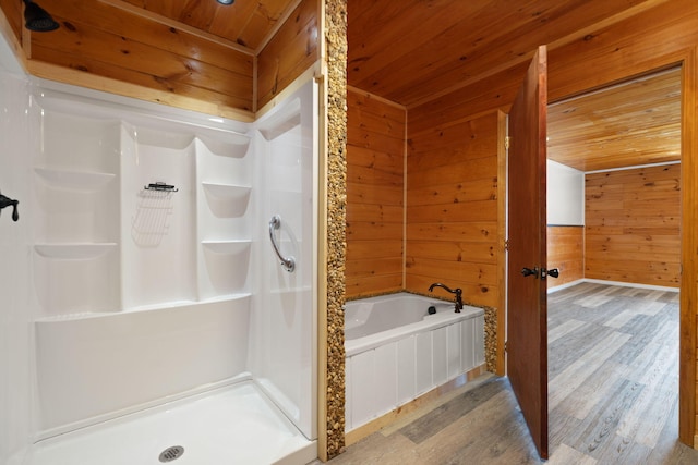 full bath featuring wooden walls, wood finished floors, a stall shower, wooden ceiling, and a bath