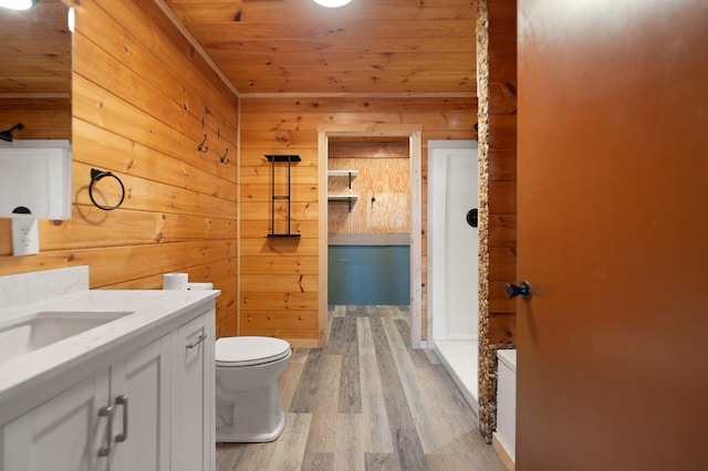 bathroom featuring wood walls and toilet