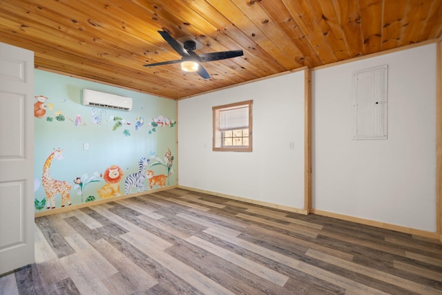 spare room with a wall unit AC, wood finished floors, baseboards, and wooden ceiling