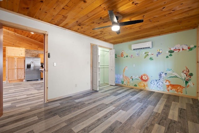 game room featuring a wall unit AC, wood finished floors, baseboards, ceiling fan, and wood ceiling