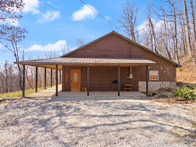 exterior space with an attached carport and metal roof