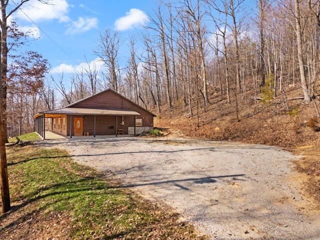 garage with a porch and driveway