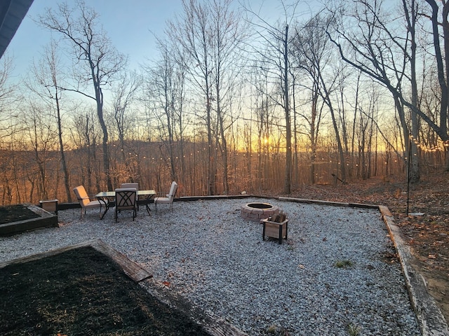 view of yard with a fire pit