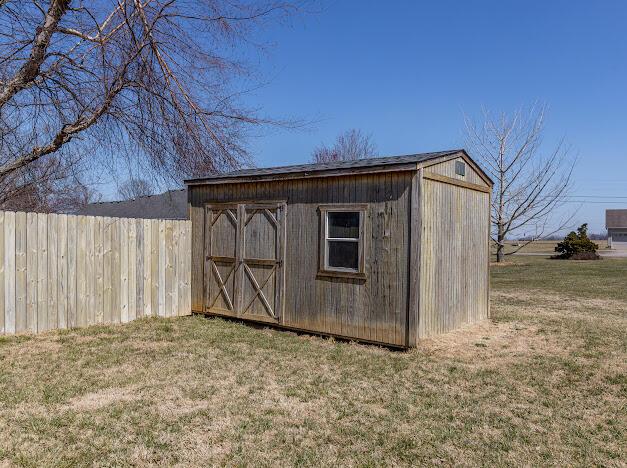 view of shed with fence