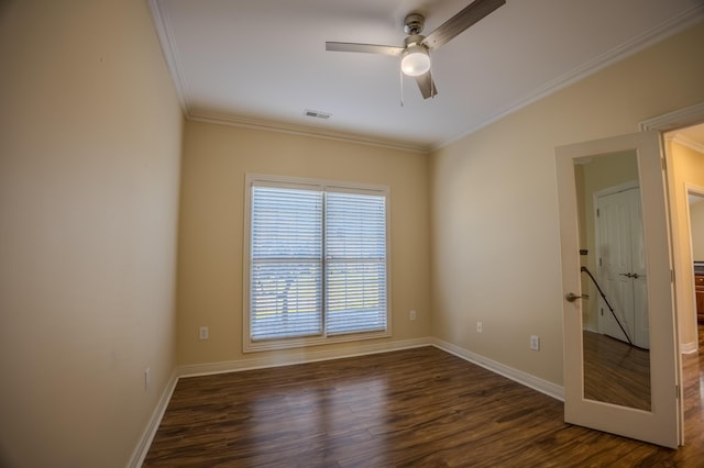 unfurnished room featuring visible vents, dark wood-type flooring, crown molding, baseboards, and ceiling fan