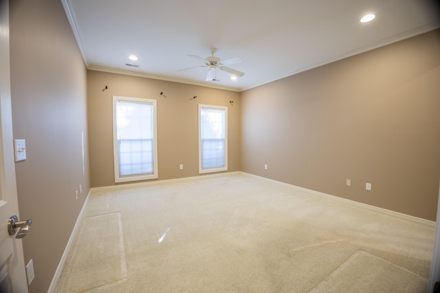 spare room featuring visible vents, baseboards, crown molding, and ceiling fan