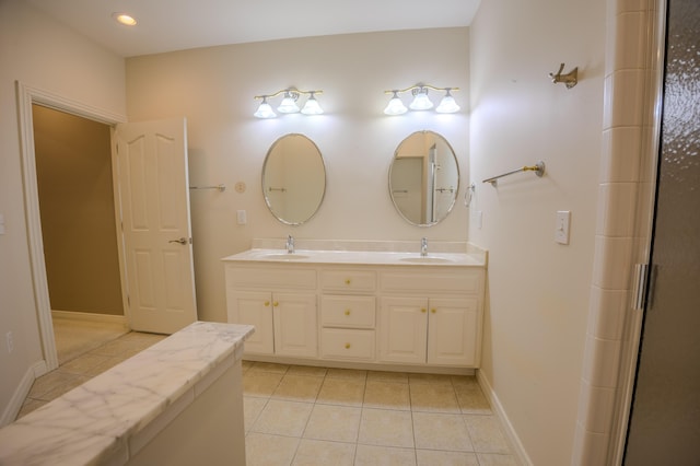 full bathroom featuring tile patterned flooring, double vanity, and a sink