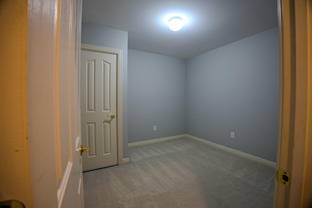 unfurnished room with carpet and baseboards