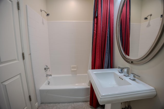 bathroom with tile patterned floors, shower / bath combination with curtain, and a sink