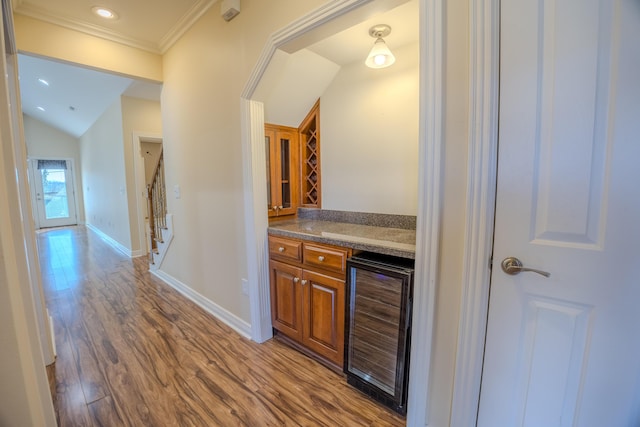 bar featuring beverage cooler, dark wood-style floors, stairway, baseboards, and a dry bar