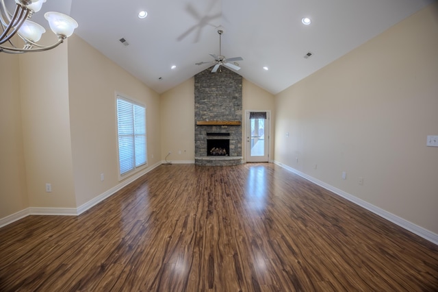 unfurnished living room with visible vents, ceiling fan with notable chandelier, dark wood-type flooring, and baseboards